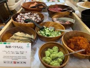a bunch of bowls of food on a table at ANA Holiday Inn Sapporo Susukino by IHG in Sapporo