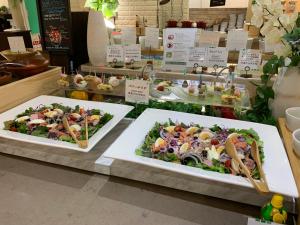 two plates of salads on display in a store at ANA Holiday Inn Sapporo Susukino by IHG in Sapporo