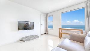a living room with a view of the ocean at Sokcho Moreve Pension in Sokcho
