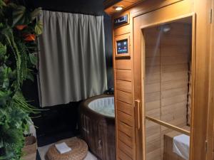 a bathroom with a tub and a shower at hôtel QUICK Palace Tours Nord in Tours