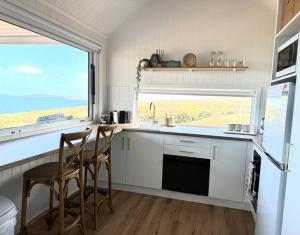 a kitchen with two chairs and a sink and a window at The Bay overlooking Boston Island in North Shields
