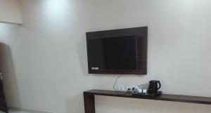 a flat screen tv hanging on a wall at Hotel Ram Janaki Palace in Tikri Kalān