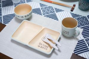two cups of coffee and a plate with a fork and knife at The Peak Tengachaya in Osaka