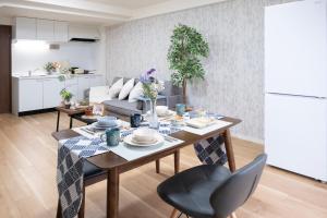 a kitchen and living room with a table and chairs at The Peak Tengachaya in Osaka