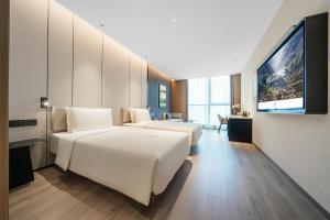 a hotel room with two beds and a flat screen tv at Atour Hotel Chongqing Liangjiang District Jinke Center in Chongqing +17 photos