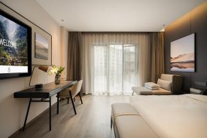 a hotel room with a bed and a desk at Atour Hotel Chongqing Bishan CBD Financial Street in Daxing