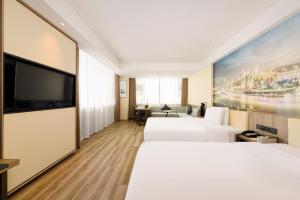 Voodi või voodid majutusasutuse Atour Hotel Chongqing Jiefangbei toas