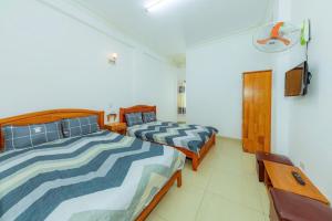 Postel nebo postele na pokoji v ubytování Reverie Hotel