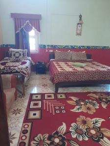a bedroom with two beds and a rug on the floor at Cliff Club Resort Ooty in Ooty +4 photos