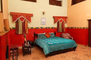 a bedroom with a bed in a red room at Cliff Club Resort Ooty in Ooty