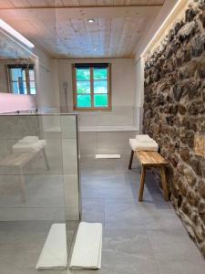 a room with a stone wall and a table and bench at Hidden Retreats 1466 Edition in Reichenbach +69 photos