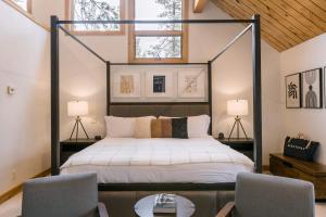 a bedroom with a bed and two chairs and a table at Coyote Moon by AvantStay Cabin WSauna Mins from DT Truckee NorthStar in Truckee