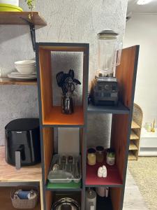 a book shelf with a blender and a blender at La Casetta, Garden Retreat in Cape Town +8 photos