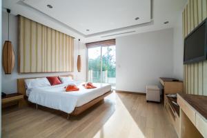 A bed or beds in a room at Bright beachfront retreat in Bang Tao