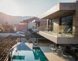 a house with a swimming pool next to a building at Luxury Villa Pearl 1 with infinity pool in Baška