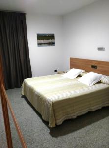 A bed or beds in a room at Hotel Albanta