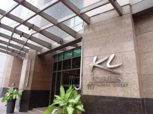 a building with a sign on the side of it at KL Rooms at Greenbelt makati with cityview in Manila
