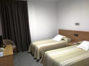 A bed or beds in a room at Hotel Albanta