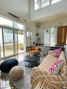 a living room with a couch and a table at Six Boutique Collection in Mannārgudi