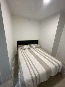 a bed with two pillows on it in a room at maisonnette de vacances in Annet-sur-Marne