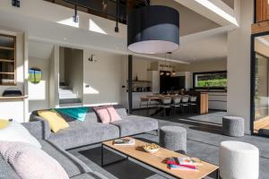 a living room with a couch and a table at Chalet Rossanaz in La Motte-en-Beauges
