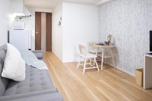a living room with a couch and a table at The Peak Tengachaya in Osaka