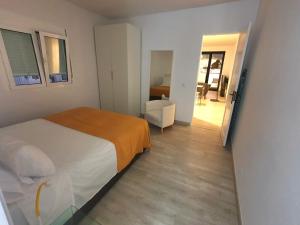 a bedroom with a bed and a chair in it at Vivienda Vacacional Fidencia in Los Llanos de Aridane