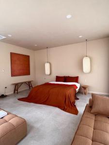 a bedroom with a bed and a couch at Nghỉ dưỡng tại TERRA VILLA in Vung Tau