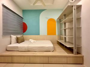 a bedroom with a bed and a shelving unit at MyStay IPOH Manhattan waterpark in Ipoh +57 photos