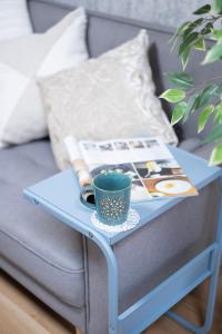 a blue coffee table with a coffee cup and a book at The Peak Tengachaya in Osaka