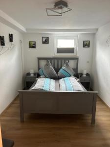 a bedroom with a large bed with pillows on it at NEU! Moderne Ferienwohnung Knüllwald in Knüllwald