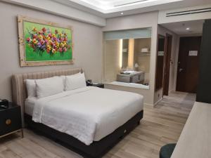 Postel nebo postele na pokoji v ubytování Trembesi Hotel