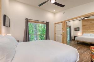 a bedroom with a large white bed and a window at Artist’s Palette by AvantStay Colorful Retreat in Fairview