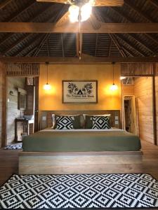 a bedroom with a large bed in a room at The Tropical Koh Mook in Koh Mook
