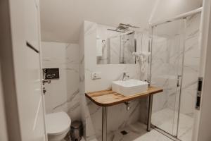 a white bathroom with a sink and a shower at Dworek Rutkowskich in Borowskie Cibory +54 photos