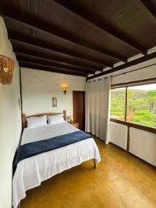 Postel nebo postele na pokoji v ubytování Cachoeira e Pousada Paraíso dos Pândavas