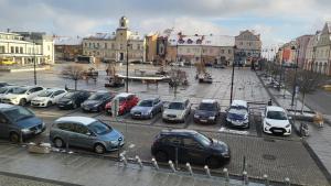 a bunch of cars parked in a parking lot at Apartamenty Długa 27 Glamour in Łomża