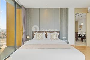 a bedroom with a large white bed with pillows at Inara by Kozystay - Cilandak in Jakarta +31 photos