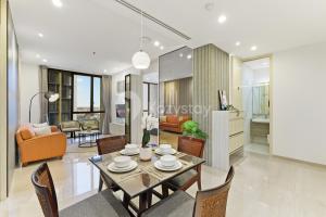 a dining room and living room with a table and chairs at Inara by Kozystay - Cilandak in Jakarta