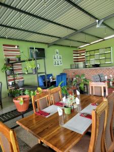 a dining room with a wooden table and chairs at Genesis Boutique Hotel in Lusaka