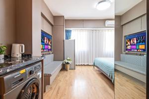 a bathroom with a washer and dryer in a room at Xi'an Yongning Apartment Hotel in Xi'an