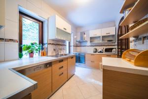 a large kitchen with wooden cabinets and a window at Villa Franica in Dubrovnik