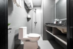 a bathroom with a toilet and a sink at Xi'an Yongning Apartment Hotel in Xi'an