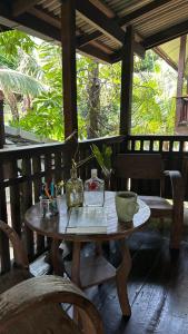a wooden table with bowls and other items on it at Boon Homestay & Cafe บุญโฮมสเตย์ in Ban Buak Khang