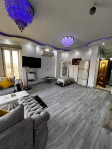 a living room with a couch and a refrigerator at شقة بإطلالة مميزة علي النيل in Cairo