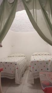 A bed or beds in a room at Trulli da Rosy