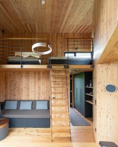 a room with two bunk beds and a staircase at Treeangle - K1 Baumhaus in Odenthal
