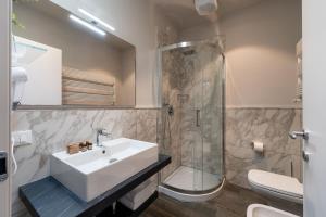 a bathroom with a sink and a shower at Corte Novella Hotel & Residence in Brescia +94 photos