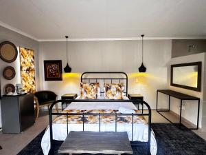 a bedroom with a bed in a room at @The Drakens Lodge in Hoedspruit +23 photos