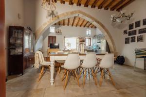 a kitchen with a table and chairs in a room at The Yard Traditional Residence in Vasa Kilaniou